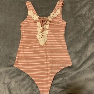 pink and white body suit